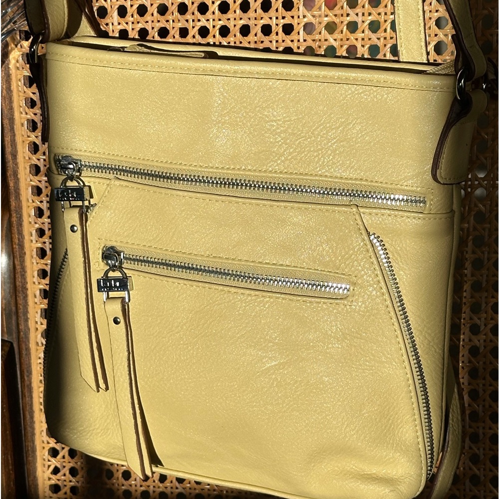 Nicole Miller crossbody purse. Adjustable strap. Zippers.